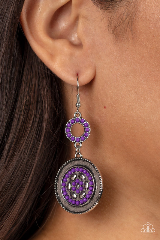 Meadow Mantra - Purple and Silver Earrings - Paparazzi Accessories - Dotted in dainty purple seed beads, a dainty silver hoop links to an ornate silver disc for a colorful floral finish. Earring attaches to a standard fishhook fitting. Sold as one pair of fashion earrings.
