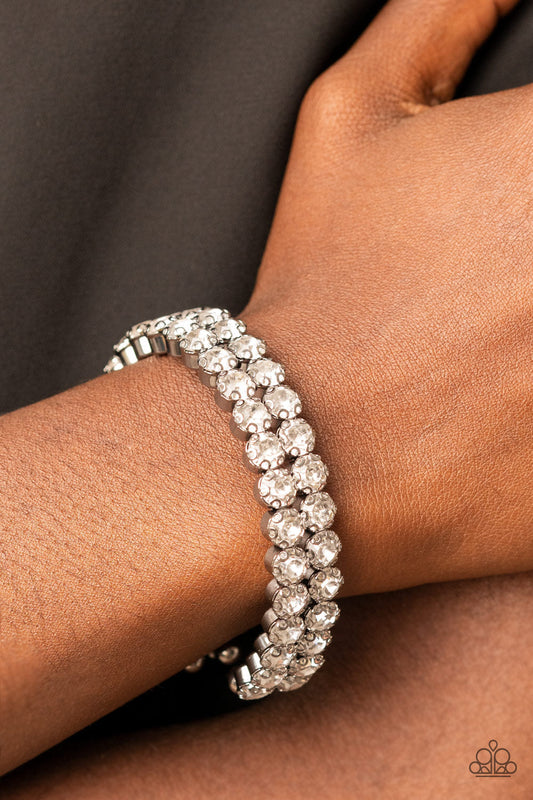 Megawatt Majesty - Black Gunmetal - Rhinestone Cuff Bracelet - Paparazzi Accessories - Encased in sleek gunmetal fittings, two oversized rows of glassy white rhinestones stack into a blinding cuff around the wrist for a jaw-dropping look. Sold as one individual bracelet.