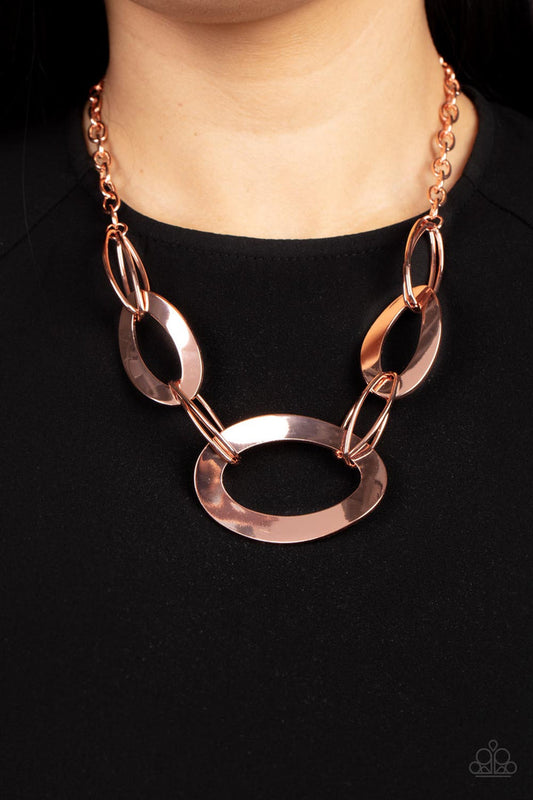METALHEAD Count - Copper Fashion Necklace - Paparazzi Accessories - Flattened shiny copper oval frames link with oval shiny copper rings below the collar, creating a gritty glamorous statement. Features an adjustable clasp closure necklace.