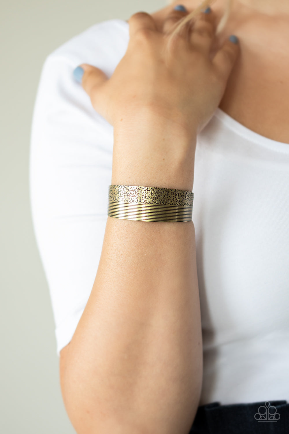 Mixed Vibes - Brass Fashion Bracelet - Paparazzi Accessories - One half of a thick brass cuff is engraved in stacked linear lines while the other half is hammered in a row of tactile textures, creating a collision of texture around the wrist. Sold as one individual bracelet.