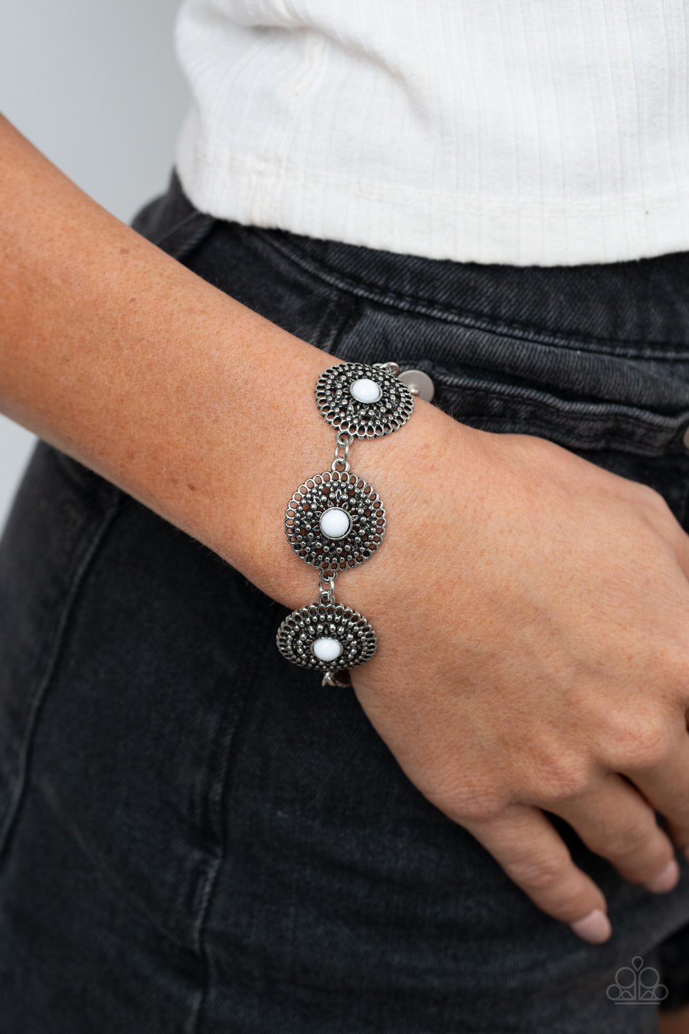 Mojave Mandalas - White and Silver Fashion Bracelet - Paparazzi Accessories - Dotted with dainty white beaded centers, shimmery studded silver floral frames delicately linked around the wrist for a colorfully whimsical look. Features an adjustable clasp closure.
