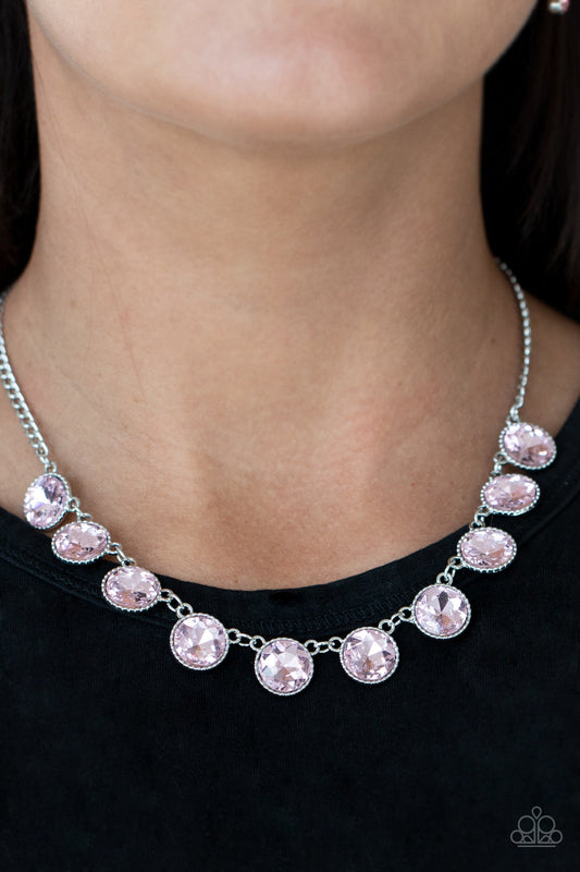 Mystical Majesty - Pink Gems and Silver Necklace - Paparazzi Accessories - 
Featuring a mystical iridescence, a sparkling display of round cut pink gems are encased in delicately textured silver frames as they link below the collar, creating a majestic statement piece. Features an adjustable clasp closure.
