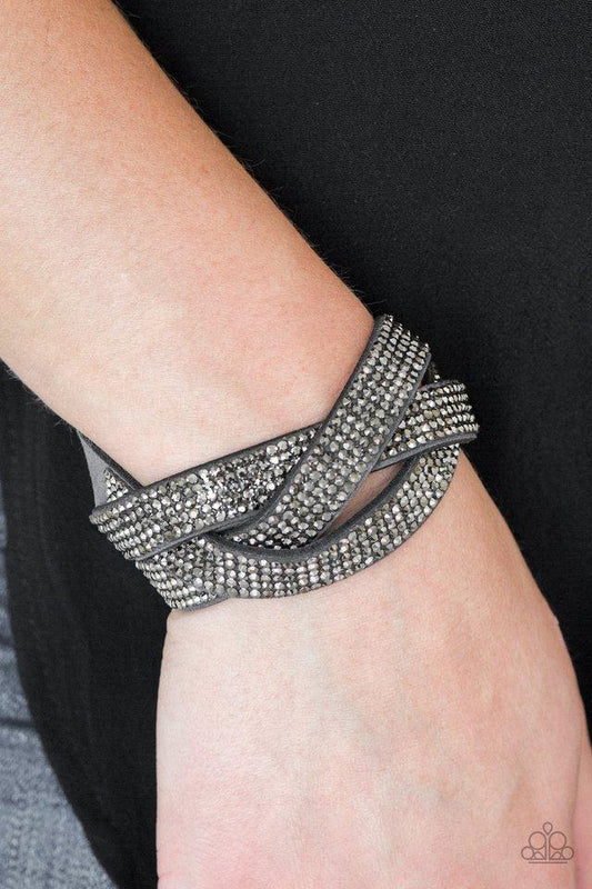 Nice Girls Finish Last - Gray Suede Snap Bracelet - Paparazzi Accessories - Encrusted in row after row of glittery hematite rhinestones, three gray suede bands braid across the wrist for a sassy look. Features an adjustable snap closure.
