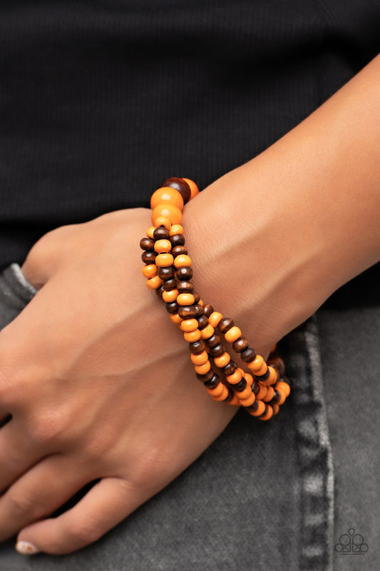 Oceania Oasis - Orange and Brown Wood Bracelet - Paparazzi Accessories - Stretchy strands of dainty brown and orange wood beads attach to a single strand of oversized brown and orange wood beads, resulting in colorful layers around the wrist.