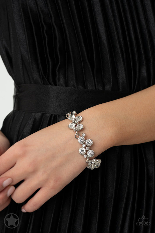 Old Hollywood - Silver Fashion Bracelet  - Paparazzi Accessories - Clusters of brilliant white rhinestones drape elegantly along the wrist. The scattered pattern and varying sizes of the rhinestones add breathtaking detail to the piece. Features an adjustable clasp closure. Sold as one individual bracelet.