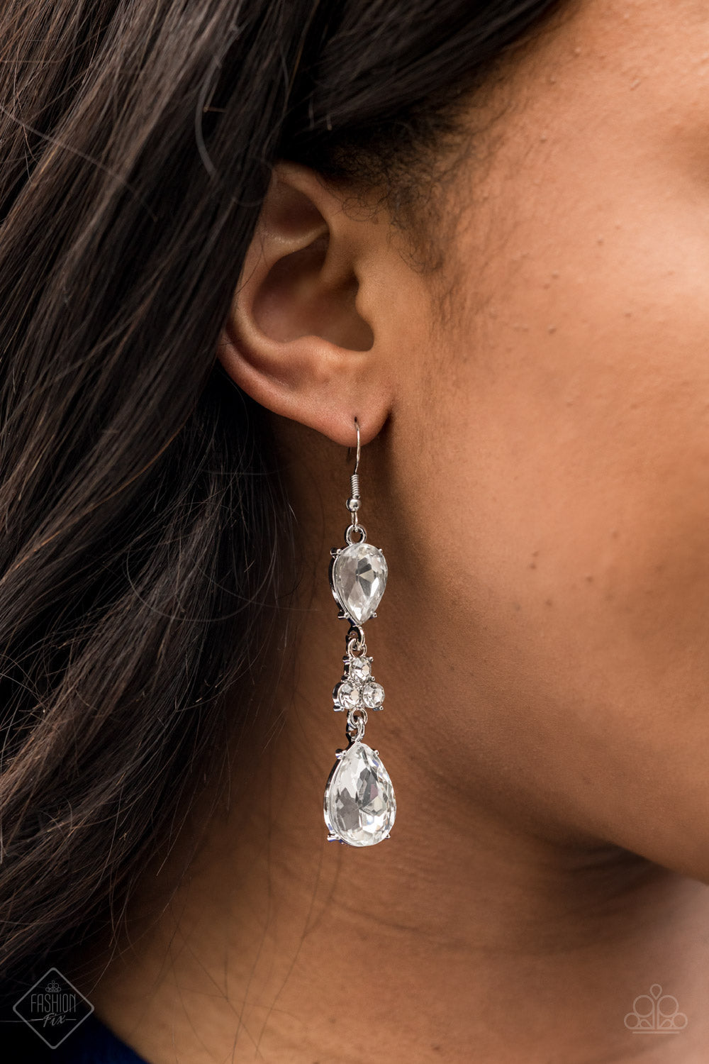 Once Upon a Twinkle - Silver Earrings - Paparazzi Accessories - A trio of dazzling white rhinestones unites two white teardrop gems as they dangle brilliantly from the ear for a flawless finish. Earring attaches to a standard fishhook fitting. Sold as one pair of earrings.
