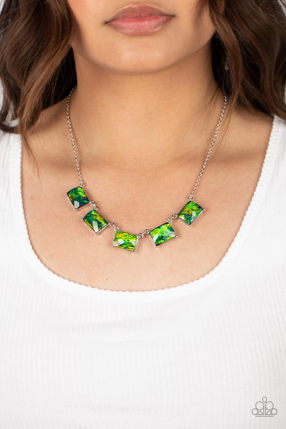Opalescent Oblivion - Green Gem and Silver Necklace - Paparazzi Accessories - Refracted shimmer and an opalescent finish, a collection of emerald-cut, glassy green gems link along the collar to create a hypnotic pop of color. Each gem is pressed into a silver frame with pronged fittings, bringing a touch of metallic grit to the design necklace.