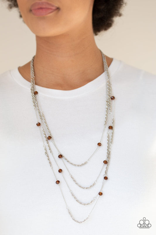 Open For Opulence - Brown and Silver Fashion Necklace - Paparazzi Accessories - Brown crystal-like beads trickle along three mismatched silver chains, creating shimmery layers across the chest. Features an adjustable clasp closure. Sold as one individual necklace.