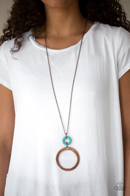Featuring a delicately hammered finish, an oversized copper hoop links with a refreshing turquoise stone ring at the bottom of a lengthened copper chain for a sophisticated look. 