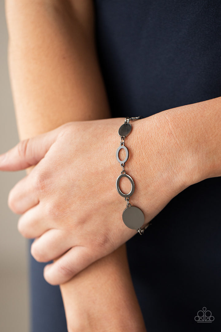 Oval and Out - Gunmetal (Black) Bracelet - Paparazzi Accessories - A shiny series of glistening gunmetal discs and oval frames delicately link around the wrist, creating a casual statement. Features an adjustable clasp closure. Sold as one individual bracelet.