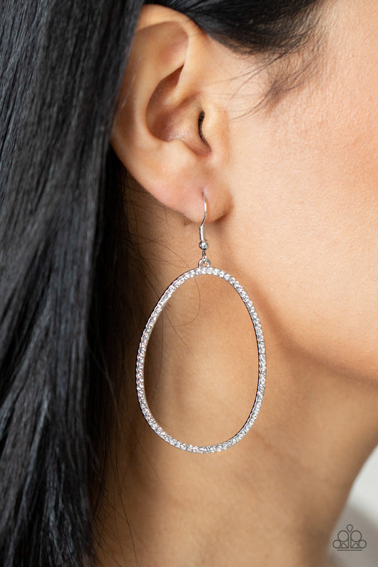 ​OVAL-ruled! - White Rhinestone - Silver Earrings - Paparazzi Accessories - 
Dotted in dainty white rhinestones, an asymmetrical oval silver frame swings from the ear for a sassy look. Earring attaches to a standard fishhook fitting.
Sold as one pair of earrings.
