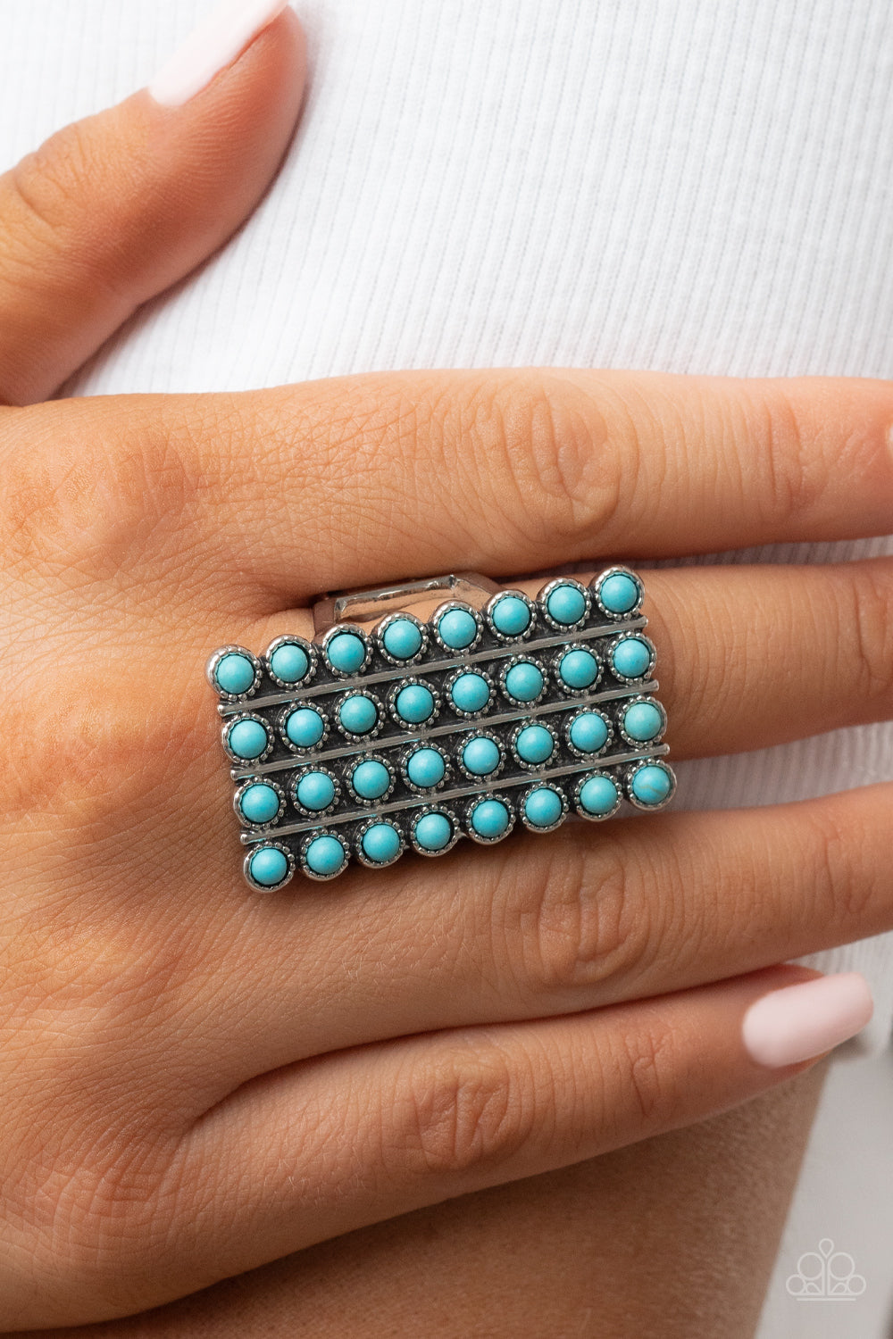 Pack Your SADDLEBAGS - Blue Turquoise Ring - Paparazzi Accessories - Bordered in antiqued silver studs, rows of dainty turquoise stones boldly stack up the finger across the front of an oversized rectangular silver frame for an earthy vibe atop the finger.