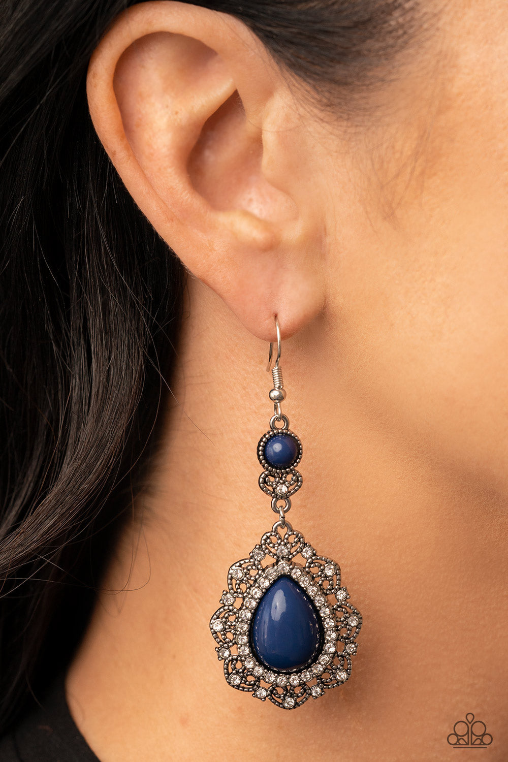 Palace Bribe - Blue and Silver Earrings - Paparazzi Accessories - An oversized Rhodonite teardrop bead is bordered in a ring of glassy white rhinestones atop a silvery backdrop of a white rhinestone dotted heart motif. The charming frame swings from a matching beaded and rhinestone encrusted fitting, resulting in a romantic dash of color. Earring attaches to a standard fishhook fitting. Sold as one pair of earrings.