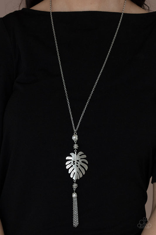 Palm Promenade - Silver Palm Leaf Necklace - Paparazzi Accessories - A lifelike silver palm leaf frame attaches to the bottom of a shimmery silver chain. A silver chain tassel swings from the bottom of this statement fashion necklace. Bejeweled Accessories By Kristie - Trendy fashion jewelry for everyone -