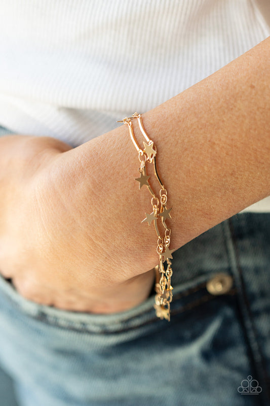 Party in the USA - Gold Star Bracelet - Paparazzi Accessories - A collection of dainty gold stars and curved gold bars delicately connect around the wrist, creating a stellar fringe. Features an adjustable clasp closure bracelet.  Bejeweled Accessories By Kristie - Trendy fashion jewelry for everyone -