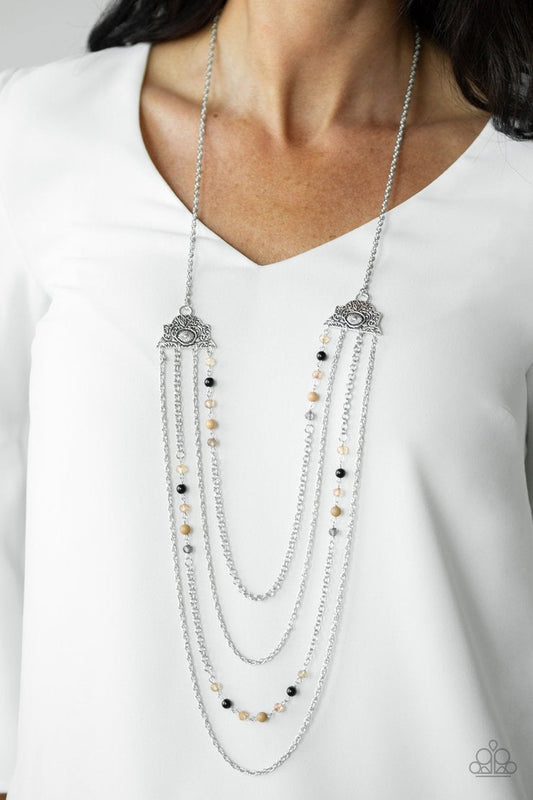 Pharaoh Finesse - Brown - Black - Silver Necklace - Paparazzi Accessories - Attached to two ornate floral silver fittings, shimmery silver chains and strands of polished brown, black, and glassy crystal-like beads cascade across the chest with a layered look.