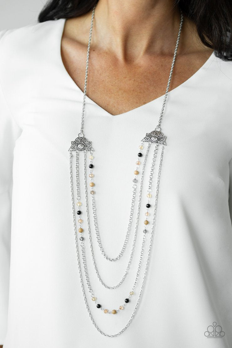 Pharaoh Finesse - Brown - Black - Silver Necklace - Paparazzi Accessories - Attached to two ornate floral silver fittings, shimmery silver chains and strands of polished brown, black, and glassy crystal-like beads cascade across the chest with a layered look. Features an adjustable clasp closure. Bejeweled Accessories By Kristie - Trendy fashion jewelry for everyone -