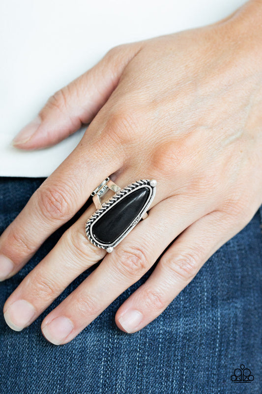 Pioneer Plains - Black and Silver Ring - Paparazzi Accessories - Chiseled into an oblong teardrop shape, an earthy black stone is pressed into an asymmetrically patterned silver frame for an artisan inspired look. Features a stretchy band for a flexible fit. Sold as one individual ring.