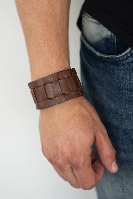 Plainly Plaited - Brown Urban Paparazzi Accessories - A brown leather band is threaded through the center of interlocking square leather links, creating a plaited pattern around the wrist. Features an adjustable snap closure.