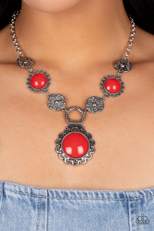 Poppy Persuasion - Red and Silver Necklace - Paparazzi Accessories - Shiny oversized red beads are wrapped in floral-inspired frames of silver, filled with studded texture. Silver discs embossed in a filigree motif alternate with the vibrant beads as they link along the collar, with a larger version of the red accents dropping below to create a whimsical pendant. Features an adjustable clasp closure.