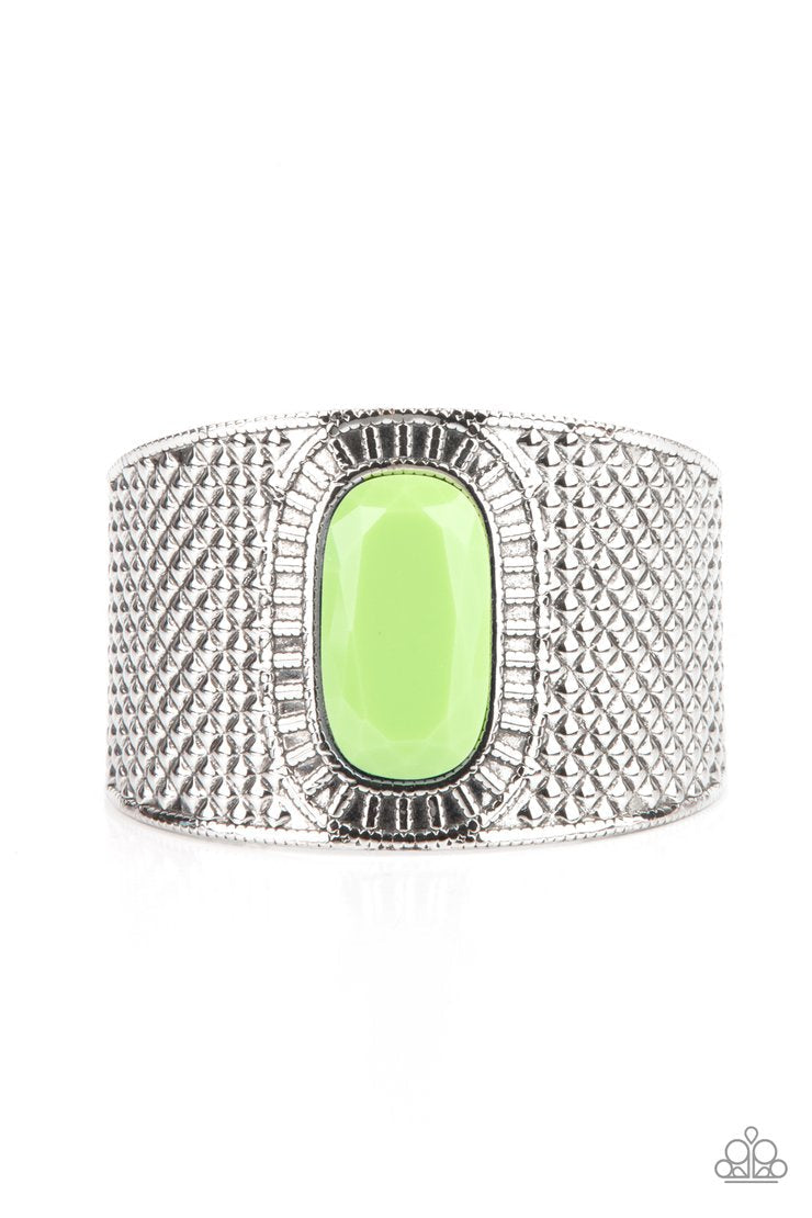 Poshly Pharaoh - Green and Silver Cuff Bracelet - Paparazzi Accessories - An oversized faceted green bead is pressed into the center of a thick silver cuff embossed in diamond-like textures, creating a bold tribal inspired centerpiece around the wrist. Sold as one individual bracelet.