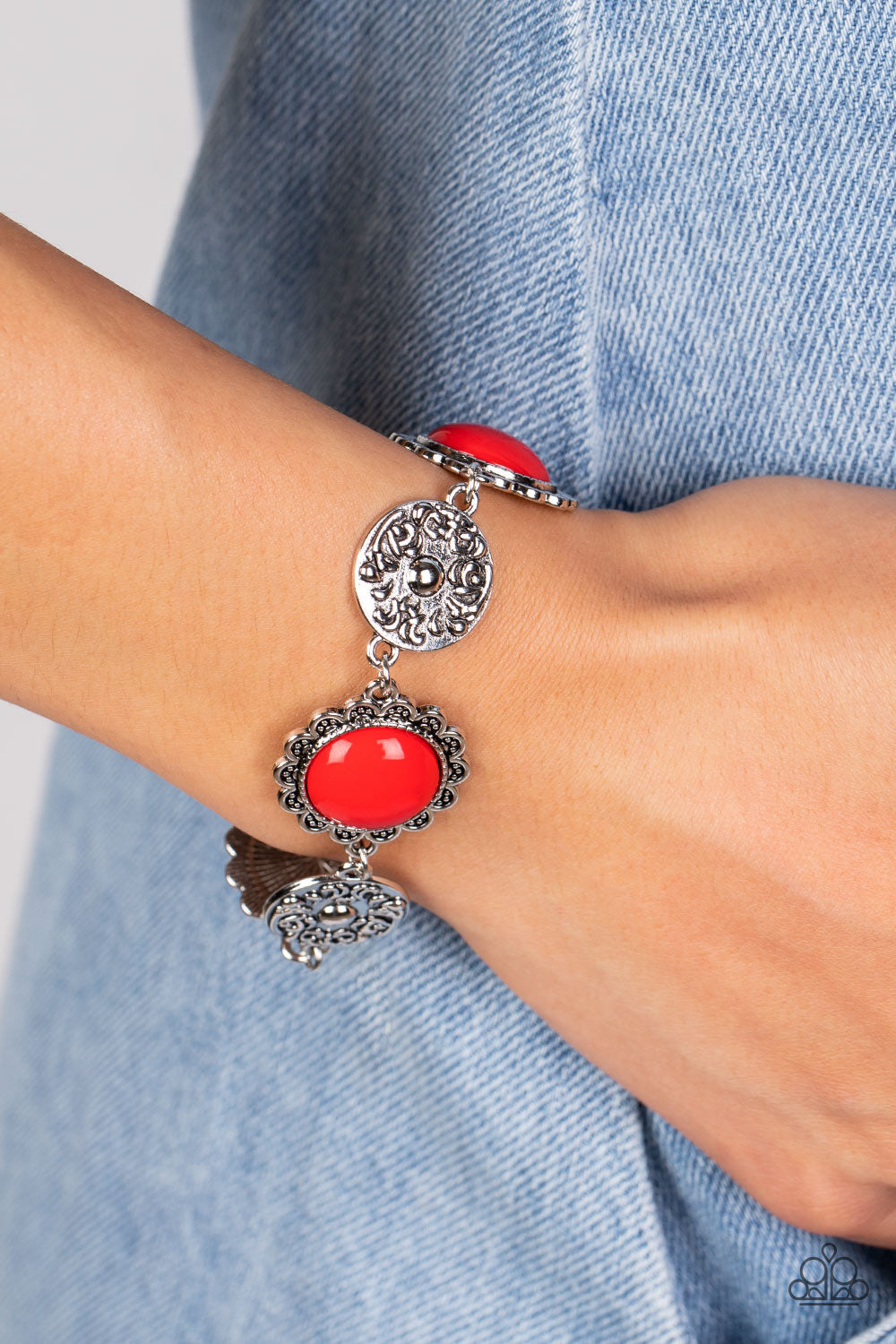 Positively Poppy - Red and Silver Bracelet - Paparazzi Accessories - Shiny oversized red beads are wrapped in floral-inspired frames of silver, filled with studded texture. Silver discs embossed in a filigree motif alternate with the vibrant beads as they link around the wrist in a whimsical finish. Features an adjustable clasp closure.