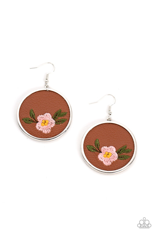 Prairie Patchwork - Pink Flower Earrings - Paparazzi Accessories - A leafy Gossamer Pink flower is embroidered along the bottom of a piece of leather that is encased in a sleek silver frame, blooming into a homespun fashion. Earring attaches to a standard fishhook fitting. Sold as one pair of earrings.