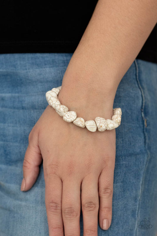 Prehistoric Paradise - White Crackle Stone Bracelet - Paparazzi Accessories - A collection of imperfect white stones are threaded along an invisible wire around the wrist, creating an earthy centerpiece. Bracelet has an adjustable clasp closure. 