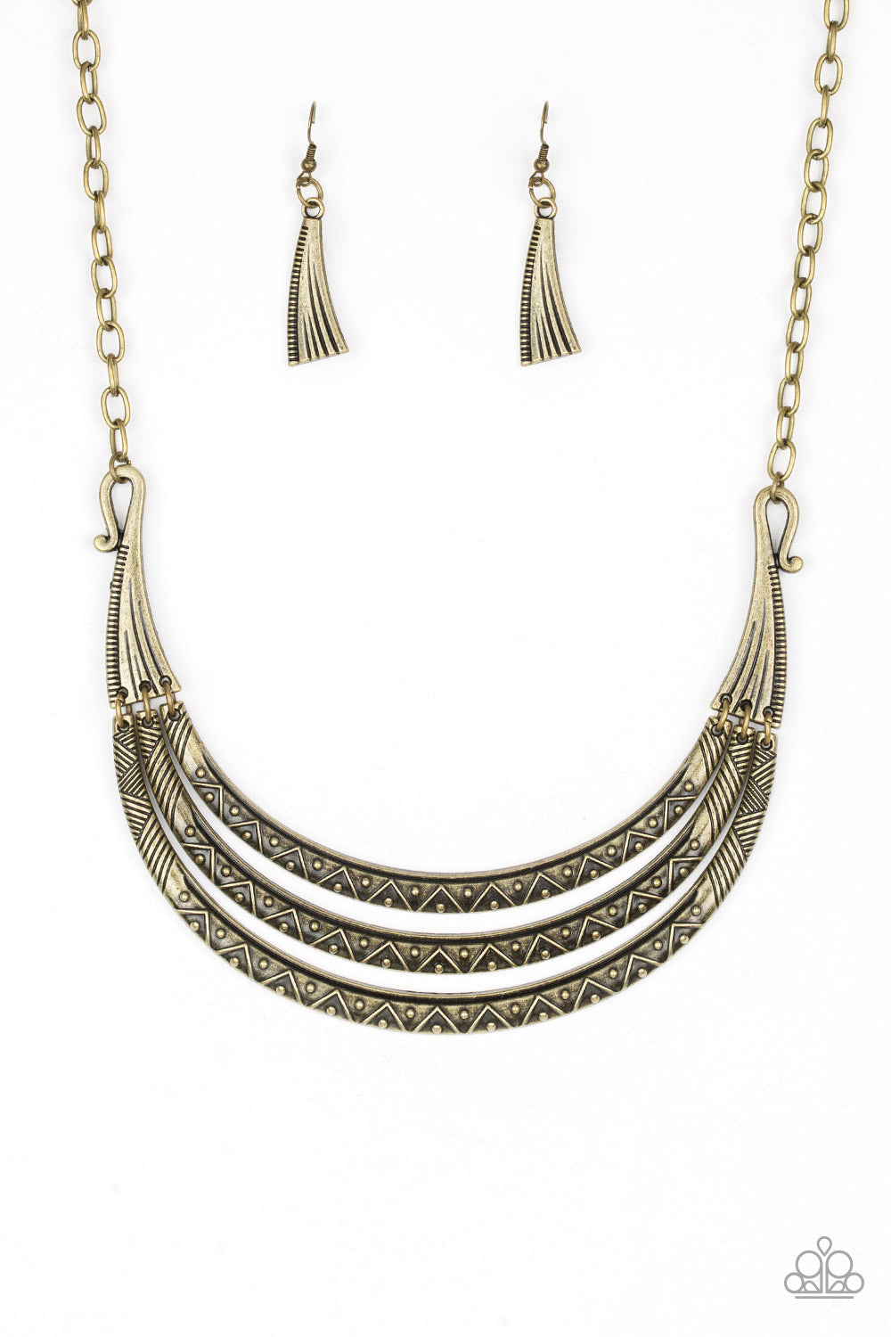 Primal Princess - Brass Fashion Necklace - Paparazzi Accessories - Embossed in zigzagging patterns brass crescents swing from two brass plates for a tribal stylish look. Dotted with studded textures the antiqued pendants stack below the collar for a bold indigenous finish. Features an adjustable clasp closure.