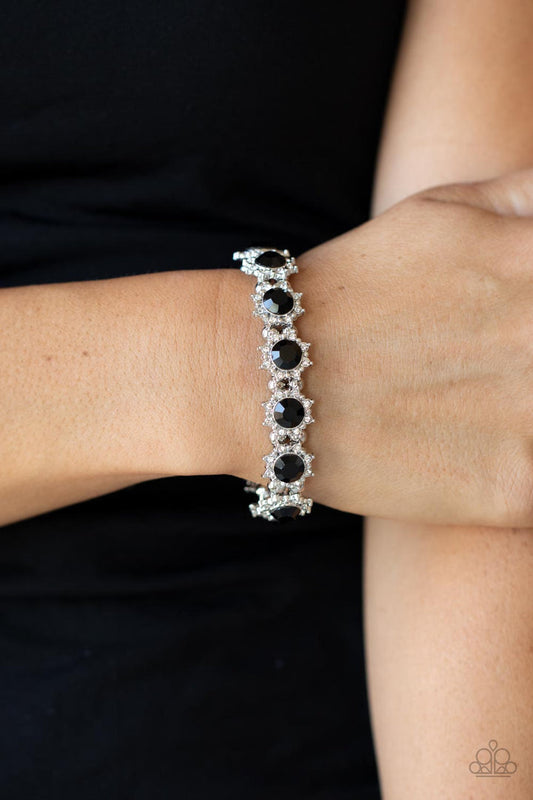 Prismatic Palace - Black and Silver Bracelet - Paparazzi Accessories - Oversized black rhinestone centers, glittery white rhinestone floral frames join pairs of classic silver beads along stretchy bands around the wrist for a glamorous display. 