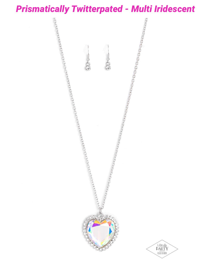 Prismatically Twitterpated - Multi Color Heart Necklace - Paparazzi Accessories - Bordered in glassy white rhinestones, an oversized iridescent heart gem sparkles from the bottom of an extended silver chain for a flirty finish. Features an adjustable clasp closure. Due to its prismatic palette, color may vary.
Sold as one individual necklace.

