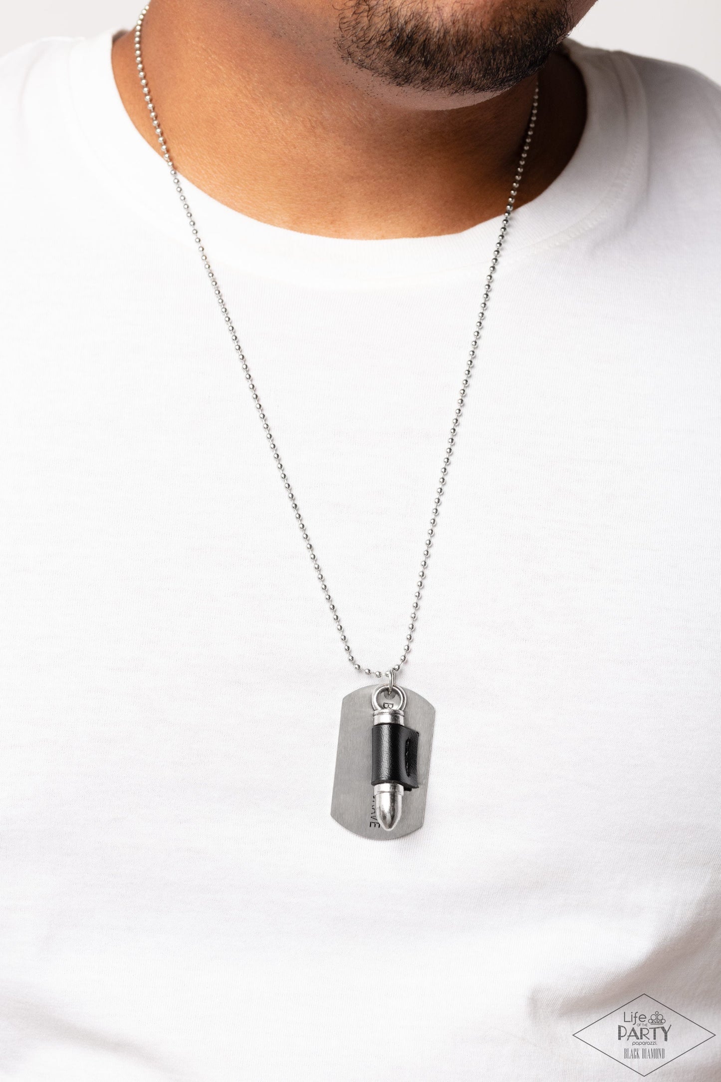 Proud Patriot - Black and Silver Urban Necklace - Paparazzi Accessories - A black leather fitting, a silver bullet pendant joins a silver dog tag at the bottom of a silver ball chain. The shimmery dog tag is stamped in the phrase, "Because of the Brave," for a patriotic finish.