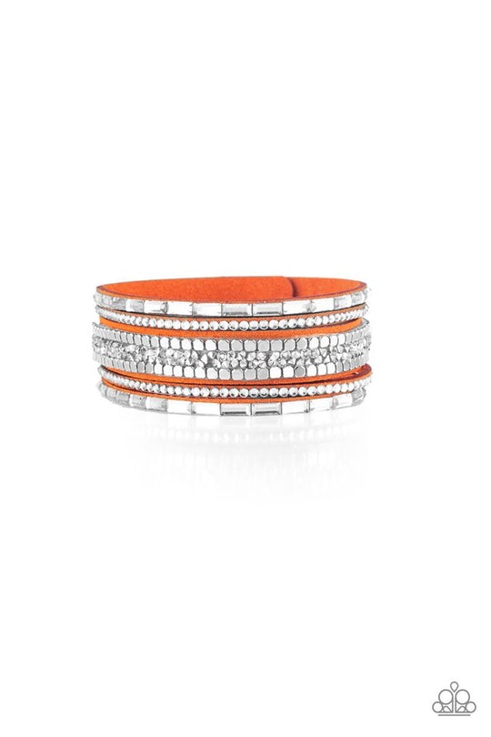 Rebel In Rhinestones - Orange Suede - Trendy Snap Closure Bracelet - Paparazzi Accessories - Round and emerald style cuts, glassy white rhinestones join flat silver cubes and metallic prism rhinestones along an orange suede band for a sassy fashion bracelet. Adjustable snap closure.