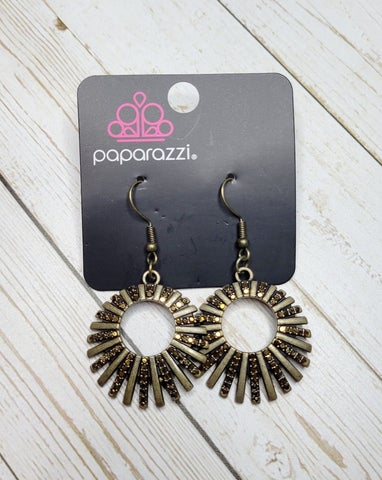 Rebel Resplendence - Brass Earrings - Paparazzi Accessories - Pressed into studded brass fittings, a collection of glittery aurum rhinestones collect inside of a hoop of brass bars, creating a sparkling frame. Earring attaches to a standard fishhook fitting. Sold as one pair of earrings.