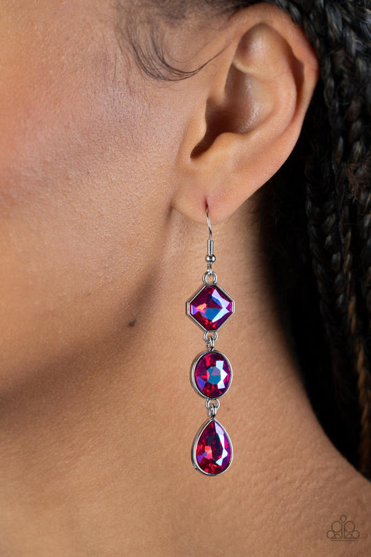Reflective Rhinestones Pink and Silver Earrings - Paparazzi Accessories - Featuring a stellar UV finish, three iridescent pink rhinestones delicately link into a refined lure. Featuring teardrop, round, and emerald style cuts, the sparkly rhinestones are delicately encased in silver frames, adding a layer of sophisticated shimmer to the glamorous look. Earring attaches to a standard fishhook fitting.