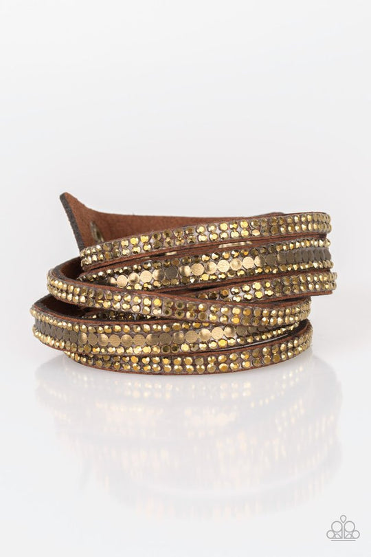 Rockstar Attitude - Brown Suede - Brass Wrap Bracelet - Paparazzi Accessories - Encrusted in rows of glittery aurum rhinestones and flat brass studs, three strands of brown suede wrap around the wrist for a sassy look. The elongated band allows for a trendy double wrap around the wrist. Features an adjustable snap closure.