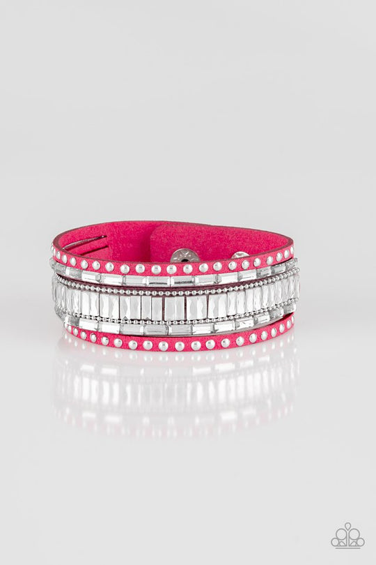 Rockstar Rocker - Pink Suede - Snap Bracelet - Paparazzi Accessories - Shiny silver studs, dainty silver ball chains, and edgy white emerald-cut rhinestones race along a spliced pink suede band for a rock star look. Features an adjustable snap closure. Sold as one individual bracelet.