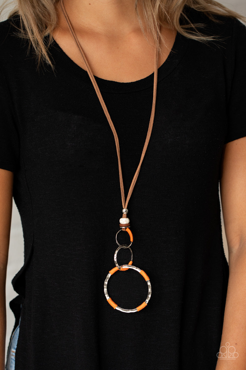 Rural Renovation - Orange - Brown Suede Necklace - Paparazzi Accessories - Wrapped in sections of orange threaded accents, a mismatched trio of hammered silver rings link at the bottom of a beaded fitting. The earthy compilation is attached to lengthened strands of brown suede for an authentic finish. Features an adjustable clasp closure. Sold as one individual necklace.