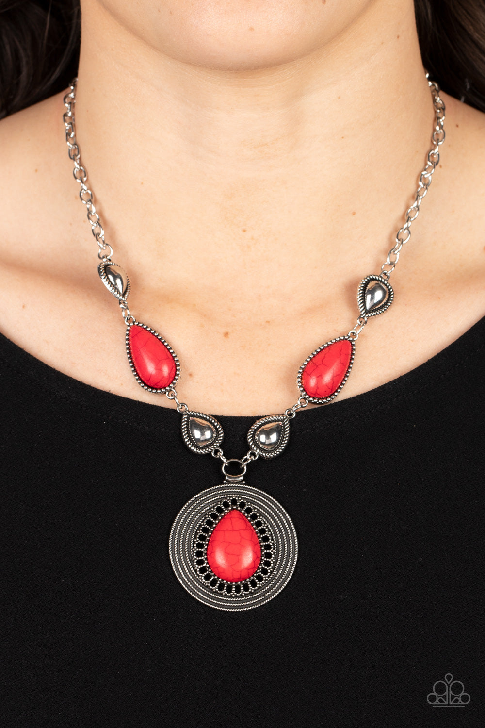 Saguaro Soul Trek - Red Stone and Silver Necklace - Paparazzi Accessories - Shiny silver teardrops alternate with red stone frames at the bottom of a silver chain. Bordered in whirls of studded details, an oversized red teardrop stone is pressed into the center of the rippling silver pendant for a hypnotic finish. Features an adjustable clasp closure. 