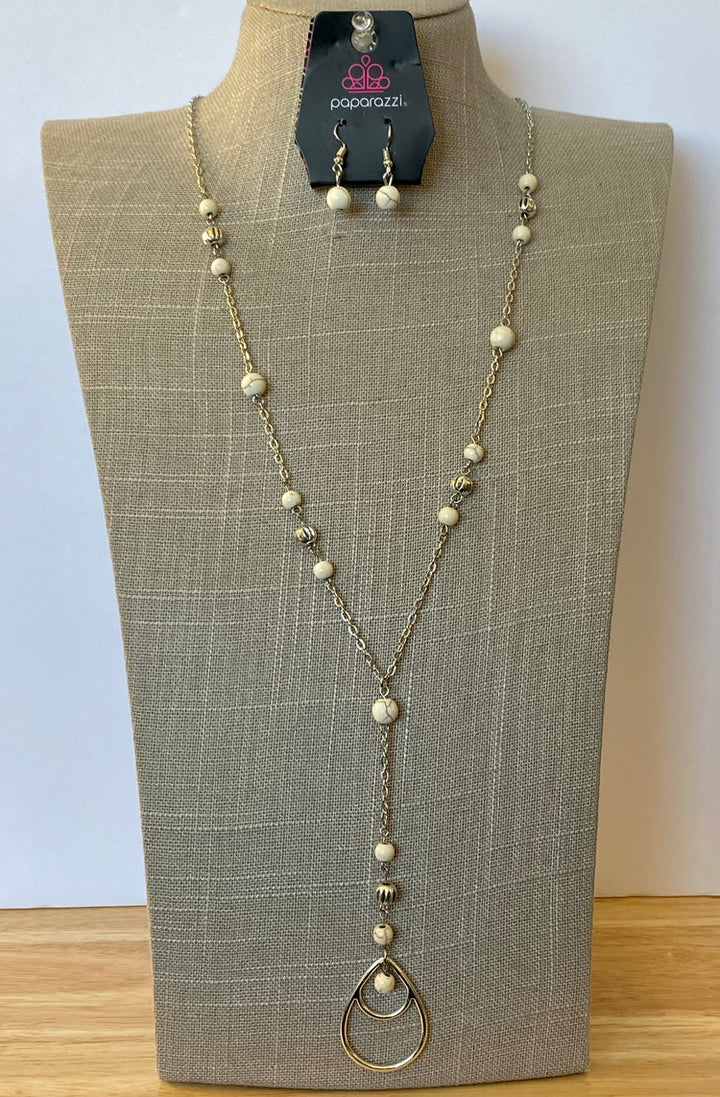 Sandstone Savannahs - White Stone and Silver Necklace - Paparazzi Accessories - Infused with ornate silver beads, earthy white stones trickle along a shimmery silver chain for a seasonal look. A glistening silver teardrop pendant swings from the bottom for a whimsical finish.