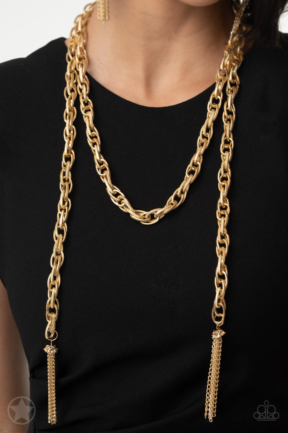 SCARFed for Attention - Gold Scarf Necklace - Paparazzi Accessories - A single strand of spiraling, interlocking links with light-catching texture is anchored by two tassels of chain that add dramatic length to the piece. Undeniably the most versatile piece in Paparazzi's history, the scarf necklace features FIVE different ways to accessorize: Open Layer, Loop, Traditional Wrap, Double Knot, and Nautical Knot. Sold as one individual necklace.