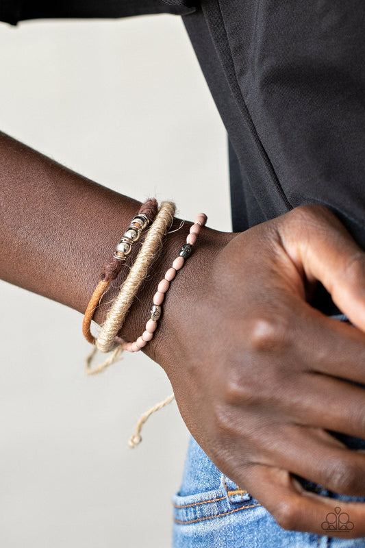 SEA You At The Beach - Multi Color Urban Bracelet - Paparazzi Accessories - Infused with wooden Rose Tan beads and mismatched silver accents, earthy strands of twine and suede cording layer across the wrist for a seasonal flair. Features an adjustable sliding knot closure. 