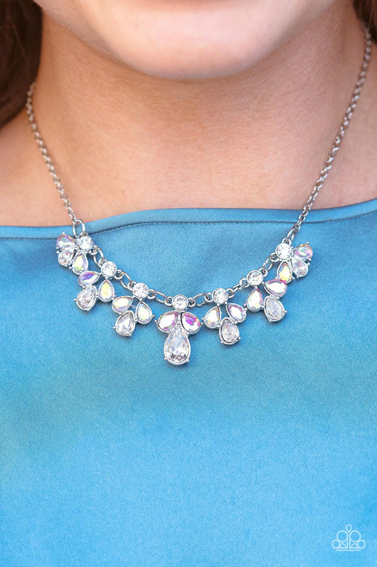 See in a New STARLIGHT - Multi and Silver Necklace - Paparazzi Accessories - Dainty white reflective gems, followed by a trio of iridescent and reflective teardrop gems vertically blaze down the collar, creating a starry shimmer. Due to its prismatic palette, color may vary. Features an adjustable clasp closure. Sold as one individual necklace.