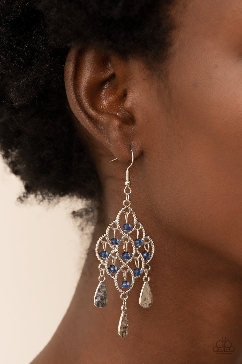 Sentimental Shimmer - Blue and Silver Earrings - Paparazzi Accessories - Hammered silver teardrops swing from the bottom of a frame composed of silvery ropelike filigree that gently loops into an airy diamond shape. Tiers of dainty blue crystal-like beads cascade from the frilly frame, adding shimmery glints of color.