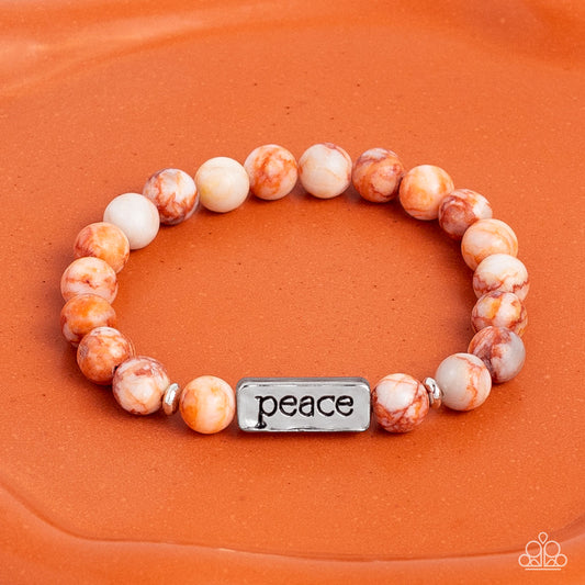 Serene Season - Orange and Silver Peace Bracelet  - Paparazzi Accessories - Meeting at the center of an elastic stretch bracelet, a silver, rectangular bar, hammered in a light sheen, is stamped with the word "peace" for a serene statement. Marbled, orange stone beads, and silver accents encircle the silver bar creating a calming, cheerful finish bracelet.
