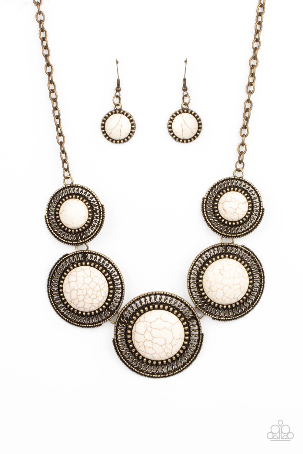 She Went West - Brass and White Stone Necklace - Paparazzi Accessories - Earthy white stones, pressed into round antiqued brass frames featuring dot and interlinking loop motifs, create a dramatically rustic statement as they link across the collar. Features an adjustable clasp closure.