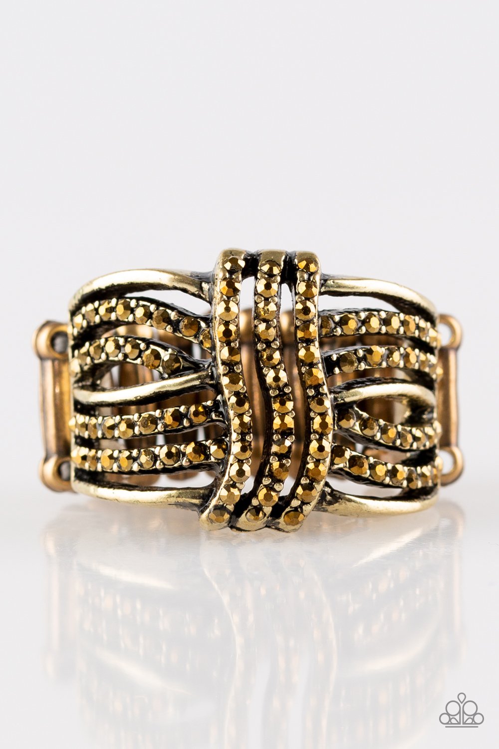 Showbiz Beauty - Brass - Topaz Ring - Flexible Fit Band - Paparazzi Accessories - Encrusted in glittery topaz rhinestones, glistening brass bands wave across the finger, stacking into a refined band. Features a stretchy band for a flexible fit. Sold as one individual ring.