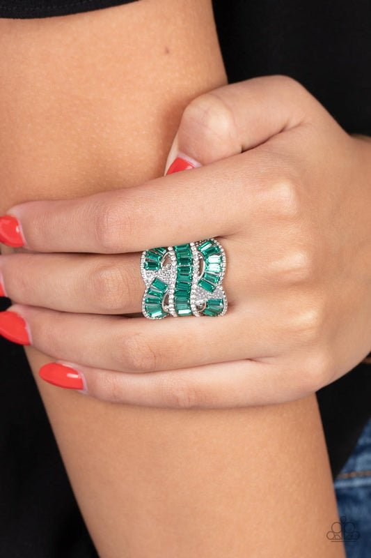 Six-Figure Flex - Green and Silver Ring - Paparazzi Accessories - Rich green rhinestones, chiseled into dramatic emerald-cuts, fall in line along twisting bands of silver. Tiny white rhinestones border the top and bottom edges of the swirling silver bands, emphasizing the shimmer as they interlock across the top of the finger.