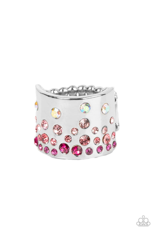 Sizzling Sultry - Iridescent Pink and Silver Fashion Ring - Paparazzi Accessories - Iridescent and glassy finishes, glitzy rows of pink and multicolored rhinestones are haphazardly sprinkled across the front of a thick silver band for a colorful splash of ombre sparkle. Features a stretchy band for a flexible fit. - Bejeweled Accessories By Kristie - Trendy fashion jewelry for everyone -