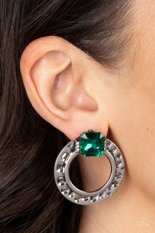 Smoldering Scintillation - Green and Silver Earrings - Paparazzi Accessories - Featuring a radiant cut, a green rhinestone sparkles between two dainty rows of glassy white rhinestones atop a hammered silver ring for a gritty yet glamorous finish. Earring attaches to a standard post fitting.